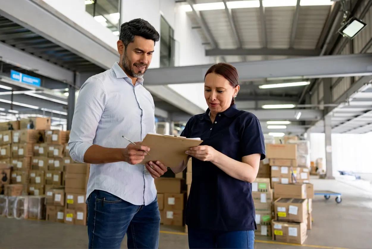 man and woman checking inventory in warehouse