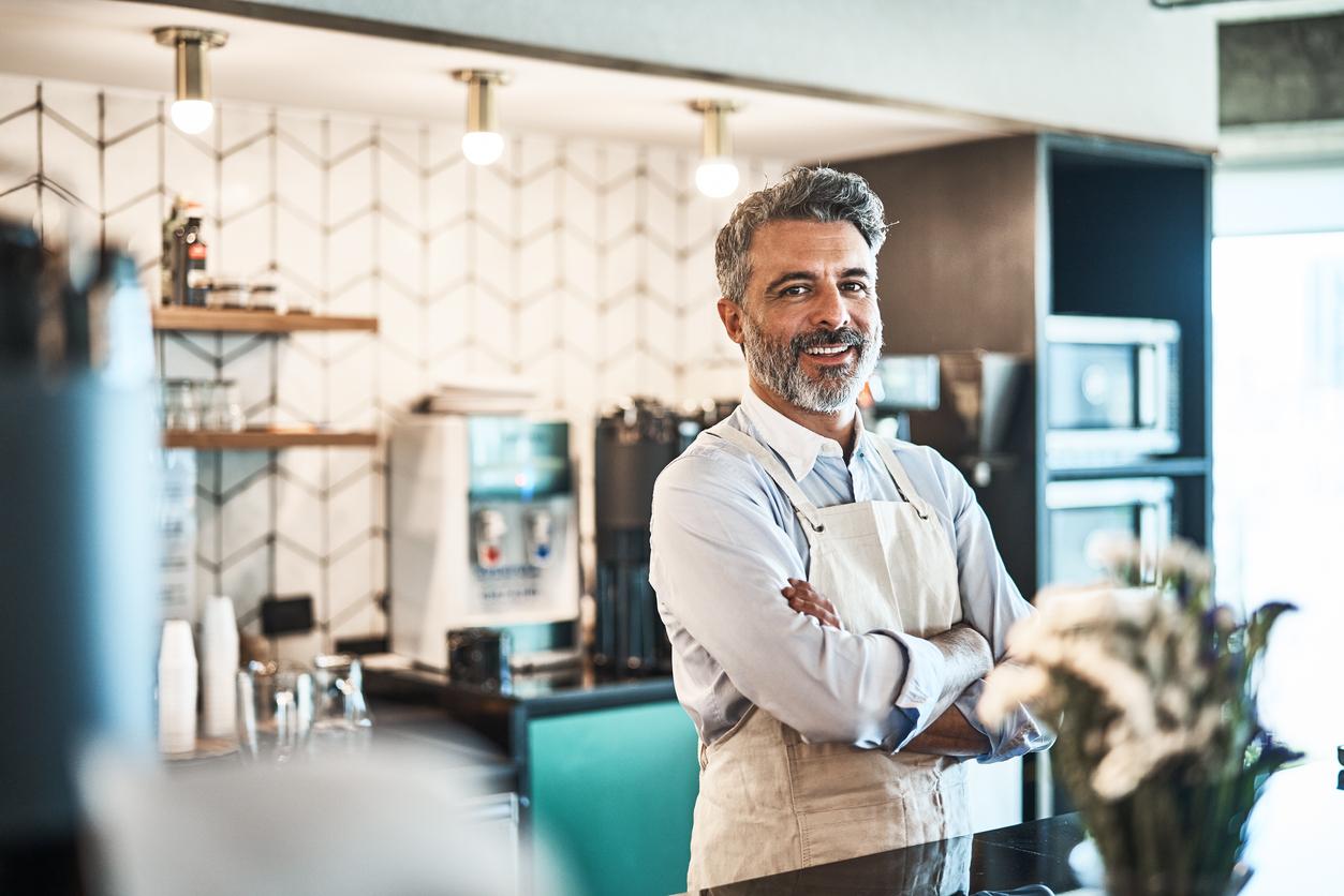 man wearing apron in a restaurant
