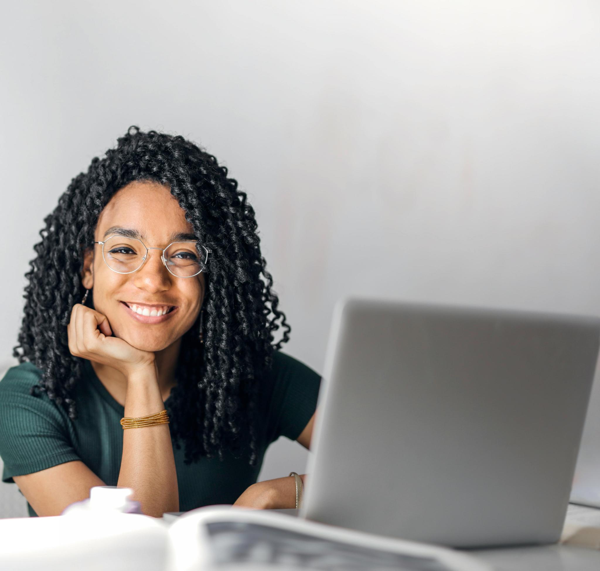 Smiling black woman with a laptop